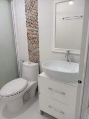 Modern white bathroom with colorful mosaic tiles