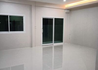 Spacious and modern living room with large windows and sliding glass door.