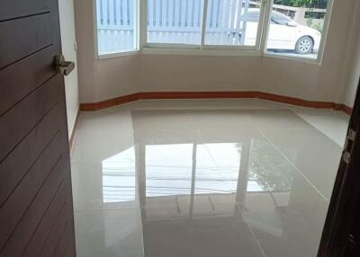 Empty room with large window and tiled flooring