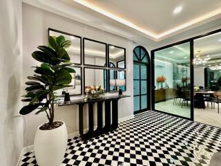 Modern living space with checkerboard flooring and large windows