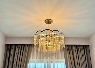 Chandelier with curtains and window