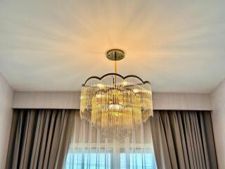 Chandelier with curtains and window