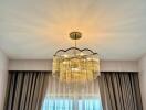 Chandelier with curtains and window