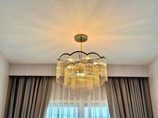 Chandelier with curtains and window