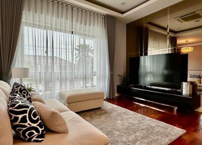 Modern living room with large TV and ample seating