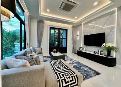 Modern living room with sofa, coffee table, and wall-mounted TV