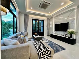 Modern living room with sofa, coffee table, and wall-mounted TV