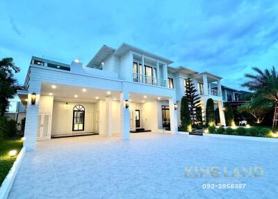 Large modern two-story house with spacious driveway and well-maintained landscaping