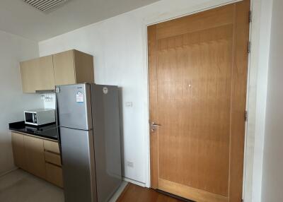 Kitchen with refrigerator and microwave