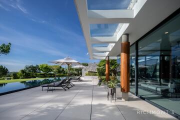 Modern outdoor patio with pool and seating