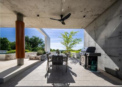 Modern outdoor patio with dining set and barbecue grill