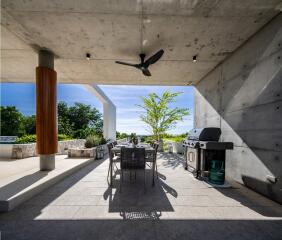 Modern outdoor patio with dining set and barbecue grill