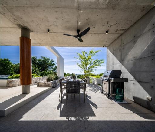 Modern outdoor patio with dining set and barbecue grill