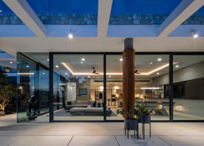 Modern living area with glass walls and ambient lighting