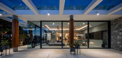 Modern living area with glass walls and ambient lighting