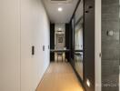 Modern hallway with built-in closets and view towards a study area