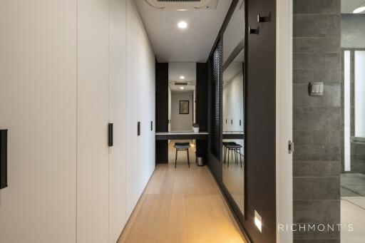 Modern hallway with built-in closets and view towards a study area