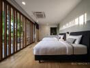 Spacious modern bedroom with large windows and twin beds