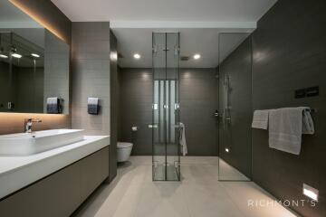 Modern bathroom with glass shower and double sink