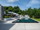 Modern outdoor pool area with surrounding greenery