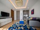 Modern living room with grey sofa, geometric rug, and entertainment center