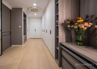 A spacious and modern hallway with built-in storage and wooden flooring