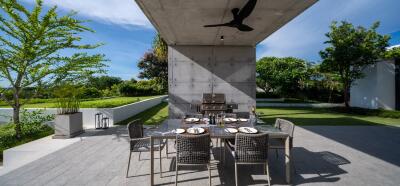 Modern outdoor dining area with table, chairs, and ceiling fan