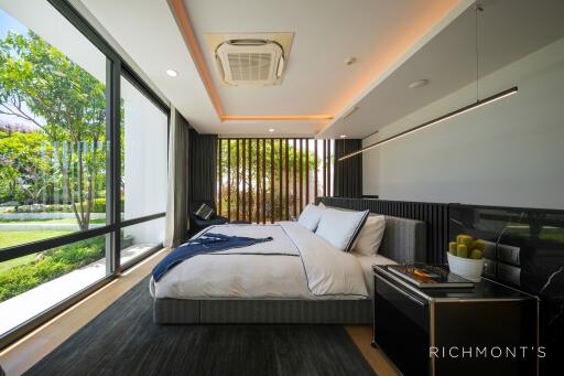 Modern bedroom with large window and garden view