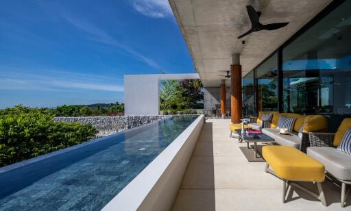 Spacious outdoor terrace with seating and infinity pool