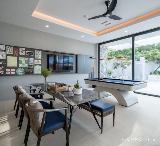 Recreational room with dining area, pool table, and large windows