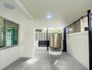 Outdoor patio area with tiled floor and water tank