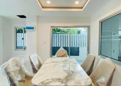 Modern dining room with marble table and chandelier