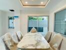 Modern dining room with marble table and chandelier