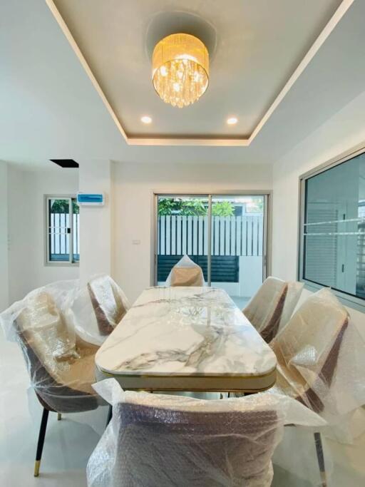 Modern dining room with marble table and chandelier