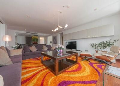 spacious living room with modern decor and vibrant rug