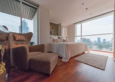 Modern bedroom with large windows and city view