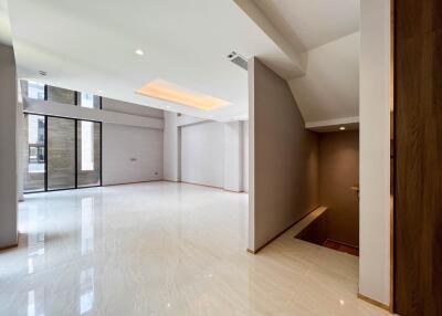 Spacious modern living room with large windows and stairs