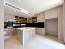 Modern kitchen with island, marble countertop, and under-cabinet lighting