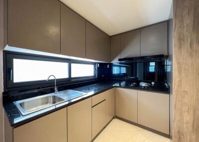 Modern kitchen with sleek cabinets and a black countertop