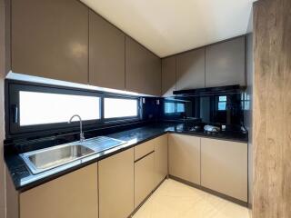 Modern kitchen with sleek cabinets and a black countertop