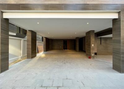 Spacious covered garage with tiled walls and floors