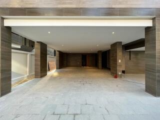 Spacious covered garage with tiled walls and floors