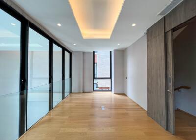 Modern hallway with wooden floors and large windows