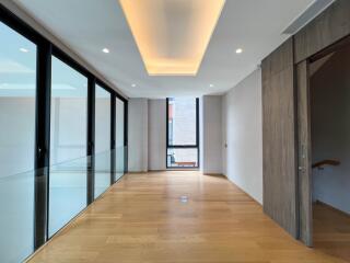 Modern hallway with wooden floors and large windows