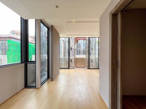 Spacious living area with large windows and wood flooring