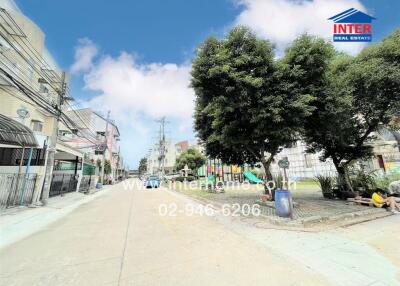 Street view of a neighborhood with trees and buildings