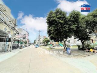 Street view of a neighborhood with trees and buildings