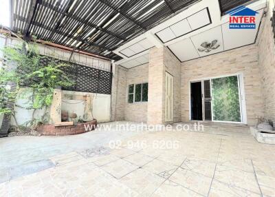 Outdoor patio with tiled flooring and green plants