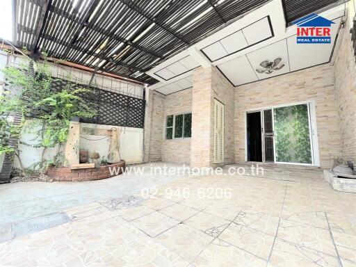 Outdoor patio with tiled flooring and green plants