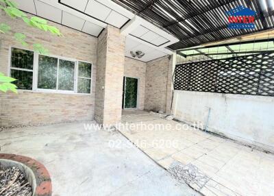 Outdoor patio with brick walls and overhead lattice structure